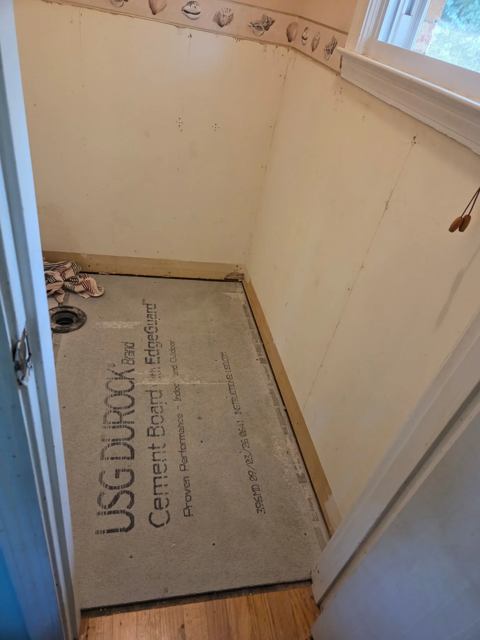 Cement board subfloor with fasteners installed in bathroom framing